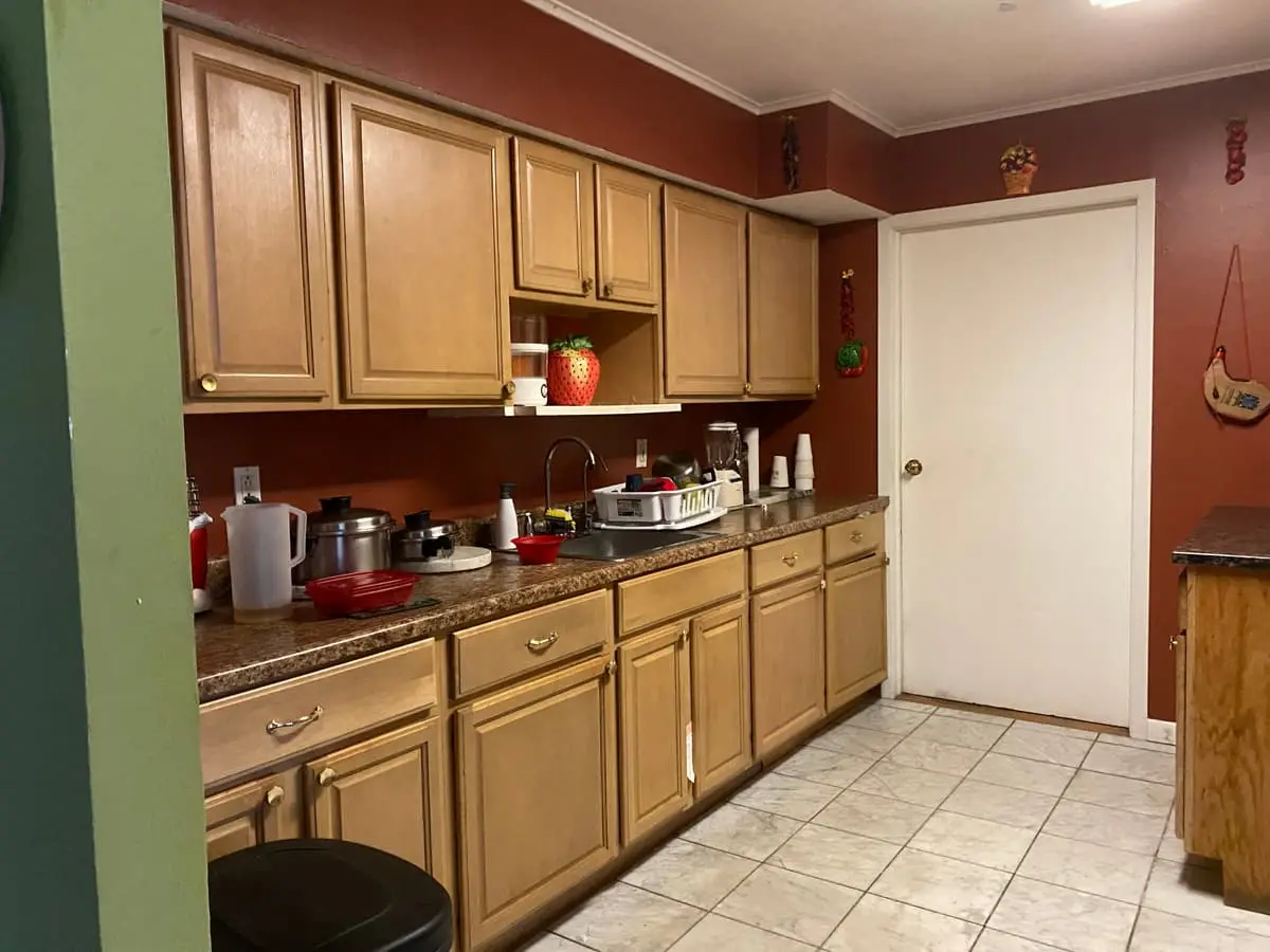 Selling without a realtor in Patchogue: occupied kitchen with oak cabinets and terracotta walls