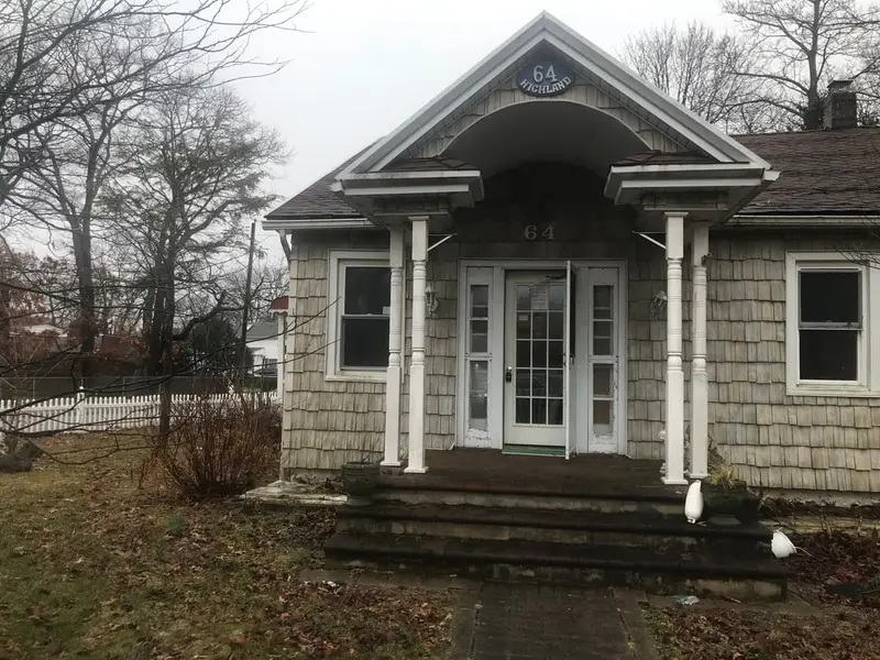 Shingled cottage with a columned front portico, Patchogue, NY
