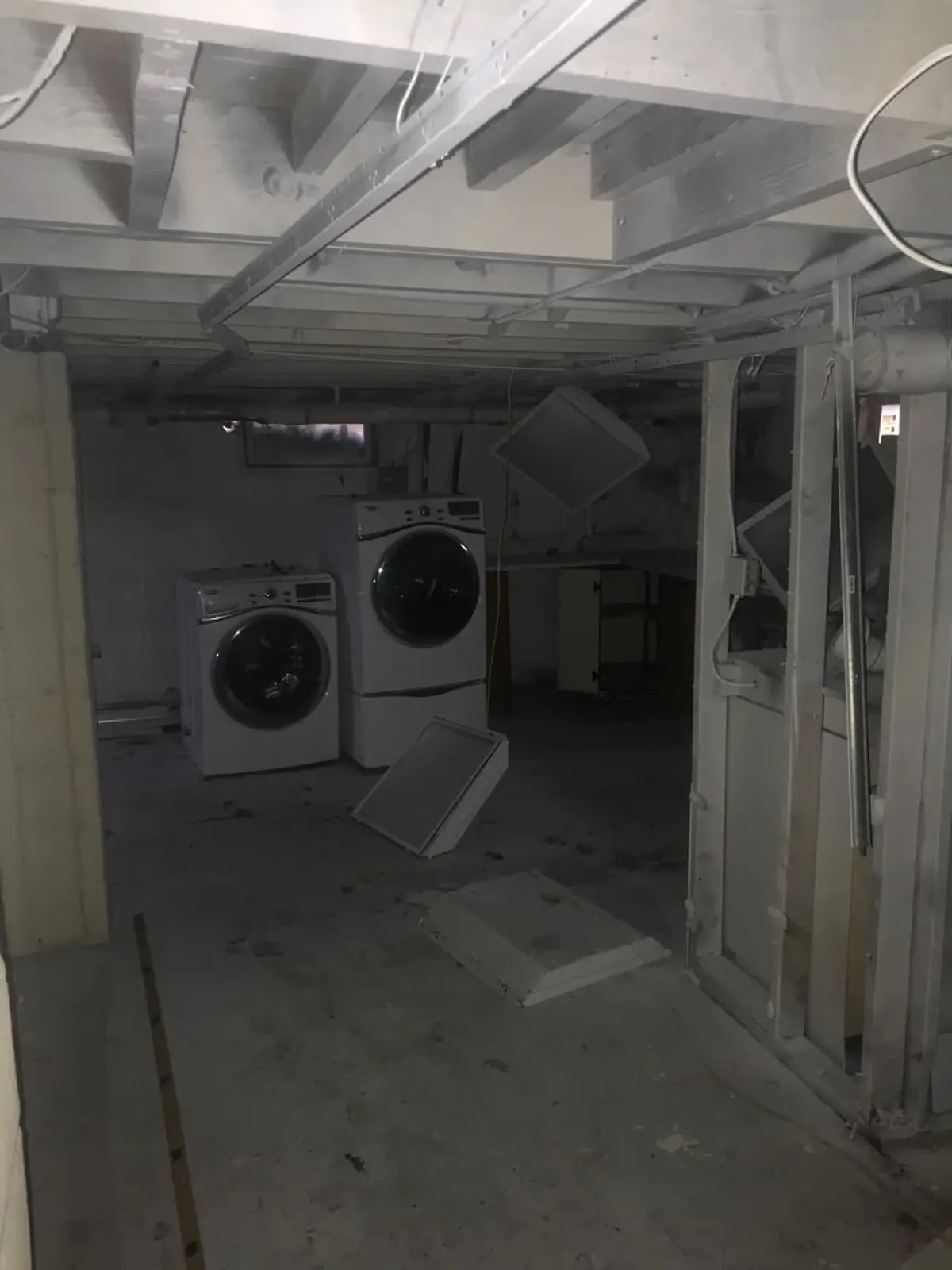 Selling a house near the LIRR in Patchogue: unfinished basement with open framing and a washer and dryer
